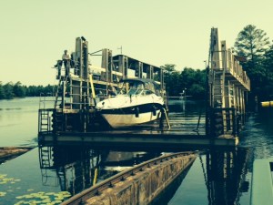 The boat is on the carriage and the cables are pulling the carriage out of the water and up from the lake at the upper level