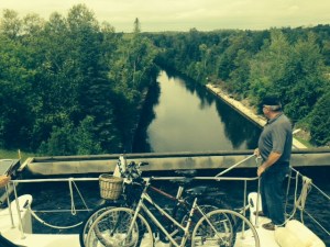 This picture is taken from the boat after we drove into the upper chamber of the Kirkfield lock. The solid wall at the front is the gate that will submerge and allow us to drive over it when the chamber reaches the lower canal, 50 feet down. Doug is deciding whether or not to jump rather than spend the rest of the week on the boat with us