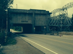 The canal at the upper level goes over the roadway - when approaching the tunnel, drivers often see a large boat above them, entering the upper chamber