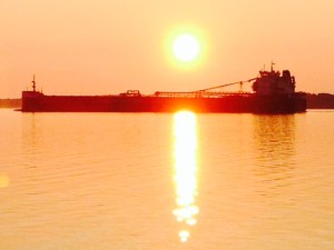 A freighter passing through the channel at DeTour at sunrise