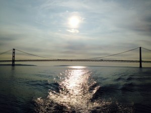 The Mackinaw Bridge with the sun rising in the background 