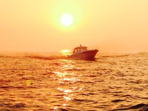 This is a boat coming into Grand Haven harbor at sunset