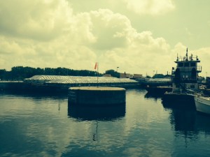 The barges that just exited the lock were parked immediately in front of the entrance to the lock. We had to pass between the concrete pier and the LaSalle, just a few feet wider than the Joint Adventure, then make a 90 degree turn to the right, then two more ninety degree turns in the narrow passage around the corner of the barge