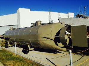 This is a replica of the Hunley, the first submarine ever to sink an enemy ship.  It was built in secrecy by the Confederacy in 1863-1864, and several crews drowned during attempts to deploy it. However, on February 17, 1864, it successfully planted an underwater charge on a union ship. The Hunley surfaced and sent a coded message of success to shore.  However, it then silently sank beneath the waves for reasons that have never been determined, drowning its 8 man crew. The Hunley was located and raised in recent years, and is on display in Charleston, South Carolina