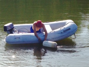 Part of the Tenn-Tom Waterway was formed by water building up behind dams. In most places, these flooded areas were not cleared of trees and debris prior  to flooding. As a result, there are fallen trees, logs, stumps, and other debris lurking below the surface in many locations. Therefore, we always attach a line to the end to the anchor with a float on the other end of the line - called a trip line -to help pull it up if it gets snagged on something or if it becomes set hard in the bottom. Paul is shortening the trip line after the anchor was set so we could better identify the location of the anchor as we swung