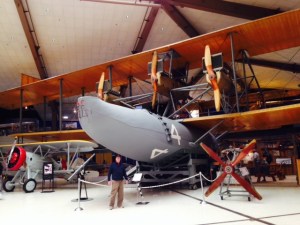 Called an NC-4, this is an early Navy "flying boat" - Jake is standing in front of it so you can gauge the massive size of it.  Three of them departed to try to fly from New York to Portugal (this was well before Lindbergh did it non-stop). Two didn't make it due to mechanical failures, but this one made it, taking 19 days (most of it on the ground on islands, including the Azores). There were no seats for the crew of three, and its cruising speed was about 80 mph