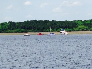 A sight all boaters hate to see - one mistake of some sort and this cruiser went aground, The red boat to the left of the cruiser is a TowBoat US boat attempting to pull the cruiser off.