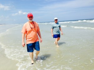 Sol walking on the sand, in the salt & surf, and also in the sun! Dave is walking behind him, watching for sharks (another "s" that he doesn't like...).