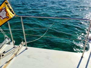 Anchoring a catamaran is a little different from anchoring a monohull. In order to ride properly at anchor, the anchor line is attached to a bridle, which is attached to the bow of each pontoon, as shown in the picture. The anchor line above the bridle is secured with slack so that the bridle takes up the force.