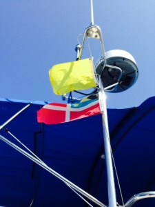 The yellow quarantine flag and the Bahamas courtesy flag on the Joint Adventure as we entered the West End
